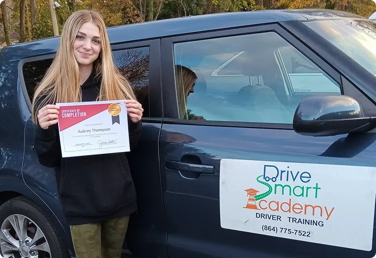 Drive Smart Academy graduate Jaycie Santana holding a certificate of completion